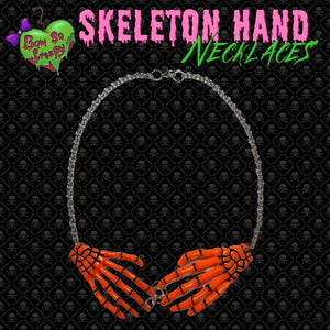 Orange skeleton hand necklace