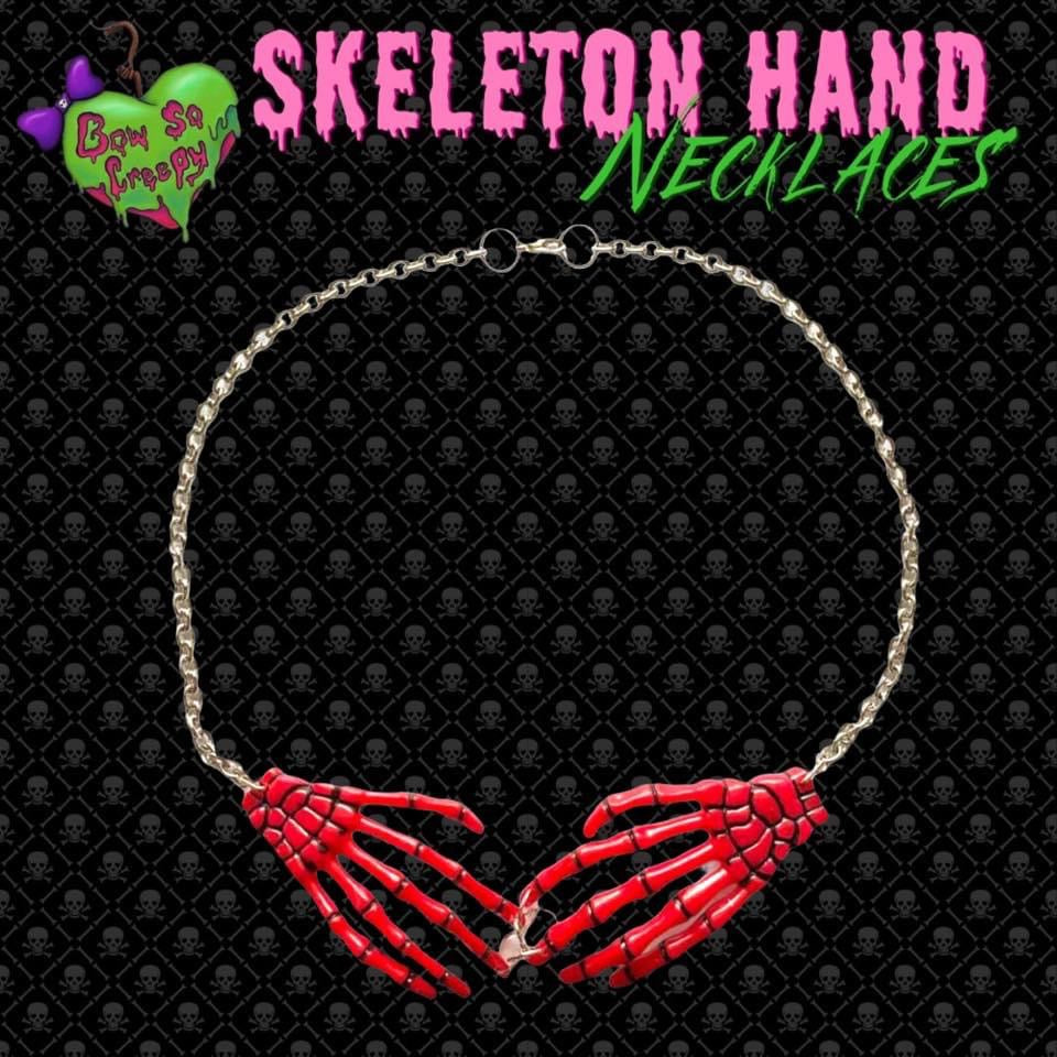 Red skeleton hand necklace